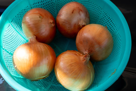 onions in a plastic colander