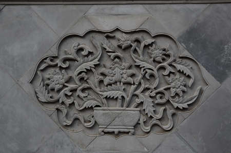 stone engraving of flowers on the wallの写真素材