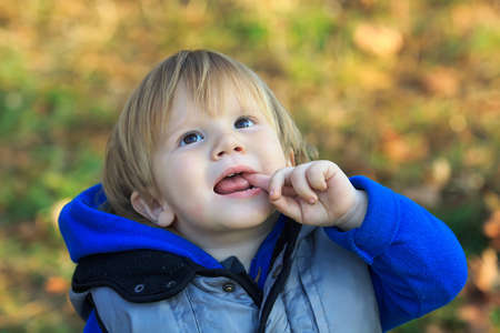 Boy looking up in a park scene