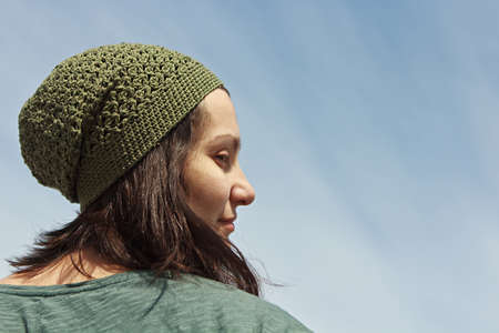 Woman in hat posing on a sky backgroundの写真素材