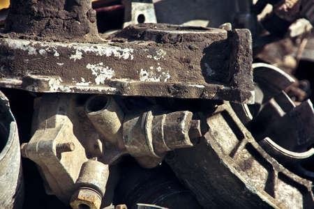 Old dirty and rusty auto parts at the dump