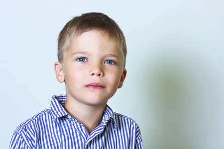 Calm portrait of 6 year old boy in a striped shirt