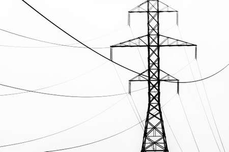 High key black and white abstract of power line towers and fog.の写真素材