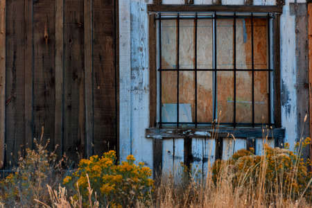 Steel bars cover windows on an old abandoned building.の写真素材