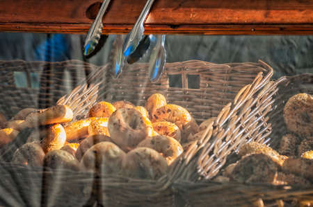 Fresh Bagels for sale, displayed behind a wooden framed glass,at  Farmers Market.の写真素材