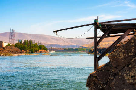 Indian fishing platforms line the shores of the Columbia River in The Dalles, Oregonの写真素材
