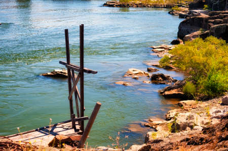 Indian fishing platforms line the shores of the Columbia River in The Dalles, Oregonの写真素材