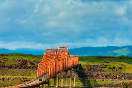 The Dalles Bridge seen and photographed from car traveling on I-84 through the Columbia Rver Gorge in Oregon.  Washington State is on the other end of the bridge that crosses the Columbia Riverの写真素材