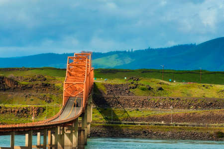 The Dalles Bridge seen and photographed from car traveling on I-84 through the Columbia Rver Gorge in Oregon.  Washington State is on the other end of the bridge that crosses the Columbia Riverの写真素材