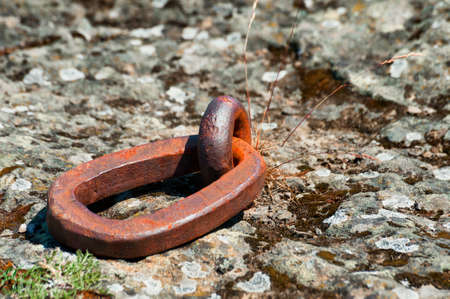 Close up of a iron ring embedded in the rock along the shores of the Columbia River in The Dalles, Oregon.   These rings are used by the Indians for securing their fishing platforms.の写真素材