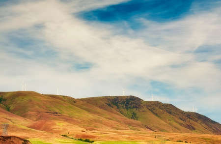 Landscape picture of distant hills dotted with wind turbines in the Columbia River Gorge.の写真素材