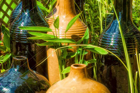 Pots arranged in a garden reflecting the sunlight.の写真素材