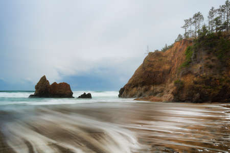 Receding storm clouds hover over Arcadia Beach near Cannon Beach, Oregonの写真素材