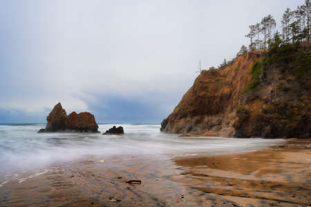 Receding storm clouds hover over Arcadia Beach near Cannon Beach, Oregonの写真素材