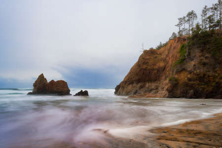 Receding storm clouds hover over Arcadia Beach near Cannon Beach, Oregonの写真素材
