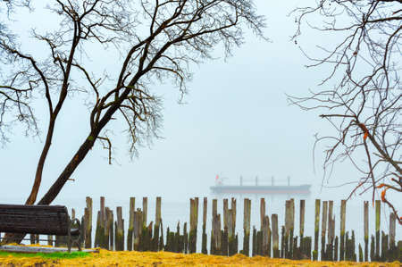 Heavy fog along Astoria's waterfront shrouds a freighter anchored in the Columbia River, in Oregon.の写真素材