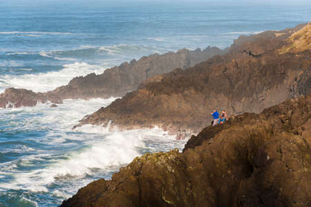 Dep Bay,Oregon,USA - January 25, 2015:  Two fishermen cast lines over the rocks and into the surf, along Otter Crest on the Oregon Coastのeditorial素材