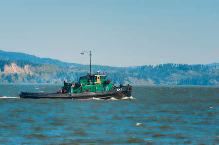 Astoria, Oregon, USA - April 7, 2016: A tug boat, seen from Astoria, Oregon's waterfront, passes by on the Columbia River.のeditorial素材