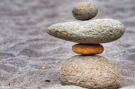 Stacks of river rocks resembling people along a sandy beach of the Sandy River in Oregon.  Many are grouped into little families, solidarity figures to for a River Rock village. Visit my blogの写真素材
