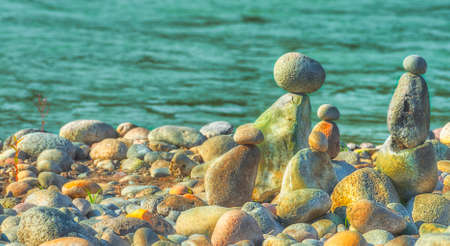 At Oxbow Park, alongd the Sandy River, has a beach where rocks are staked by anyone who visits the area creating a village of stacked rocks.の写真素材
