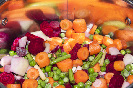 pot with uncooked vegetablesの写真素材