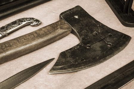 Swords, knifes and battle-axes on the table