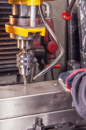 in metal workshop - drolling