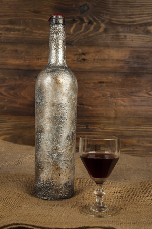 old wine bottle and glass of wineの写真素材