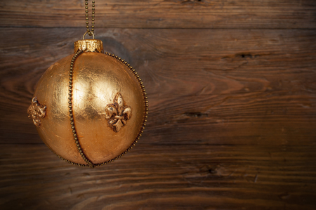 handmade golden chrostmas ball on wooden backgroundの写真素材