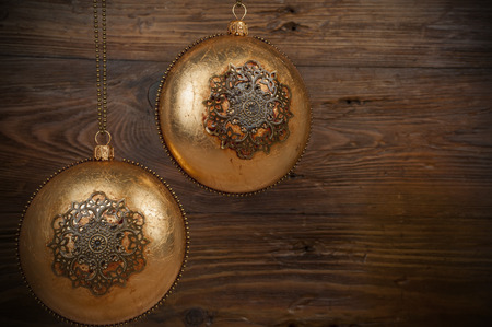 handmade golden chrostmas ball on wooden backgroundの写真素材