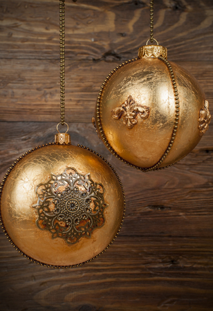 handmade golden chrostmas ball on wooden backgroundの写真素材