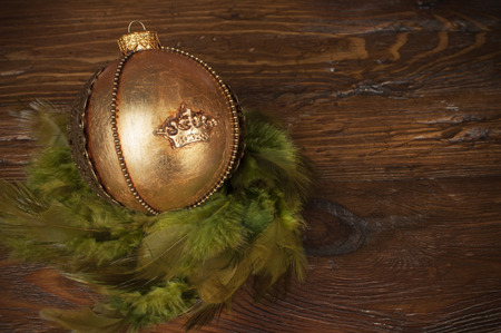 handmade golden chrostmas ball on wooden backgroundの写真素材