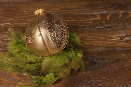 handmade golden chrostmas ball on wooden backgroundの写真素材