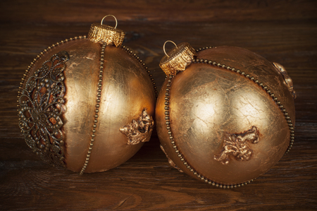handmade golden chrostmas ball on wooden backgroundの写真素材