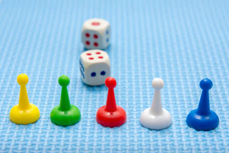 Board game concept. Dice, chips, figures on a blue background.
