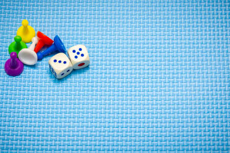 Board game concept. Dice, chips, figures on a blue background.の写真素材