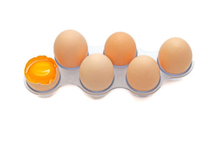 Fresh Eggs in the refrigerator tray. Six homemade eggs. White background. isolate.
