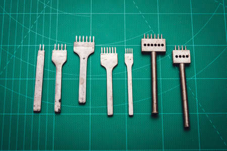 Tanner tools. A leather craftsman makes leather wallets. Men's wallets and tools. Tanner business.