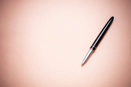 Ballpoint pen on yellow paper background. Ballpoint pen for writing and signatures. Also, the pen is used in business to sign documents.の写真素材