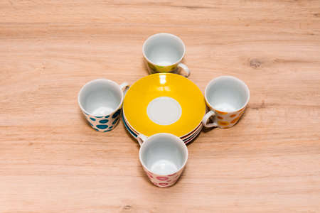 Four cups and saucers. Cups on a light wooden background.の写真素材