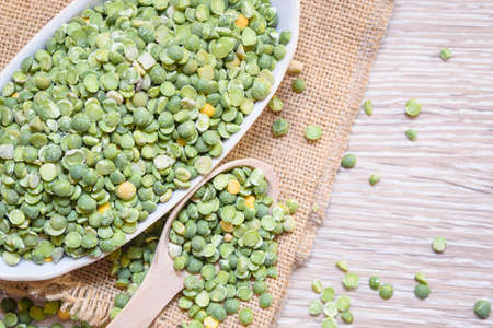 Legumes, soup peas are scattered over the cloth mat. Dried peas, legumes.の写真素材