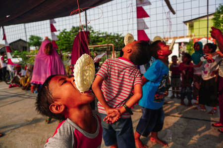 Jakarta, Indonesia - August 17, 2018: portrait of indonesia crackers eating competition on independence day celebrationのeditorial素材