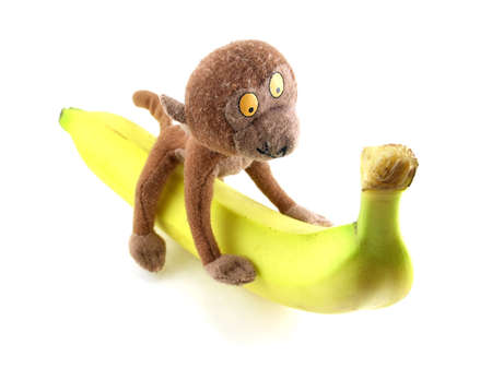 funny toy monkey sitting on a banana. Isolatedの写真素材
