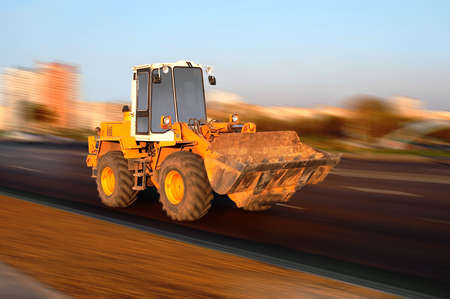 excavator moving on a roadの写真素材