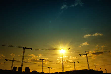 Construction site with cranes silhouettesの写真素材