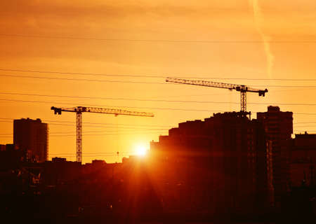 tower cranes at construction site of city buildings