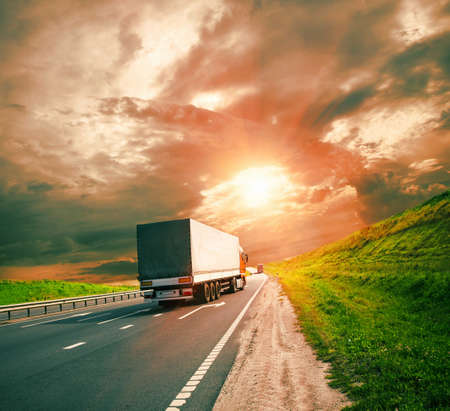 trucks under colorful skyの写真素材