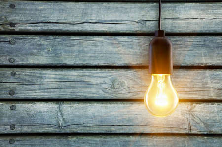 Light bulb lamp on wooden background with copy spaceの写真素材