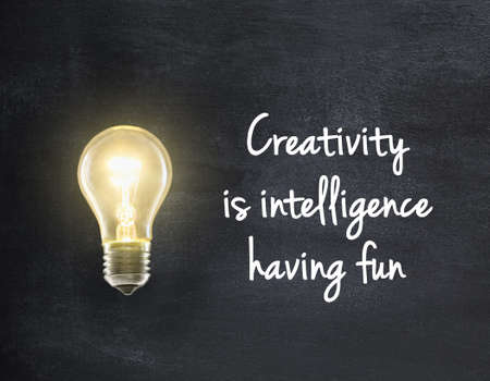 Light bulb lamp on blackboard background with creativity quoteの写真素材