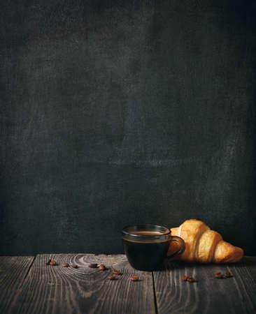 coffee and croissant on blackboard background. copy spaceの写真素材